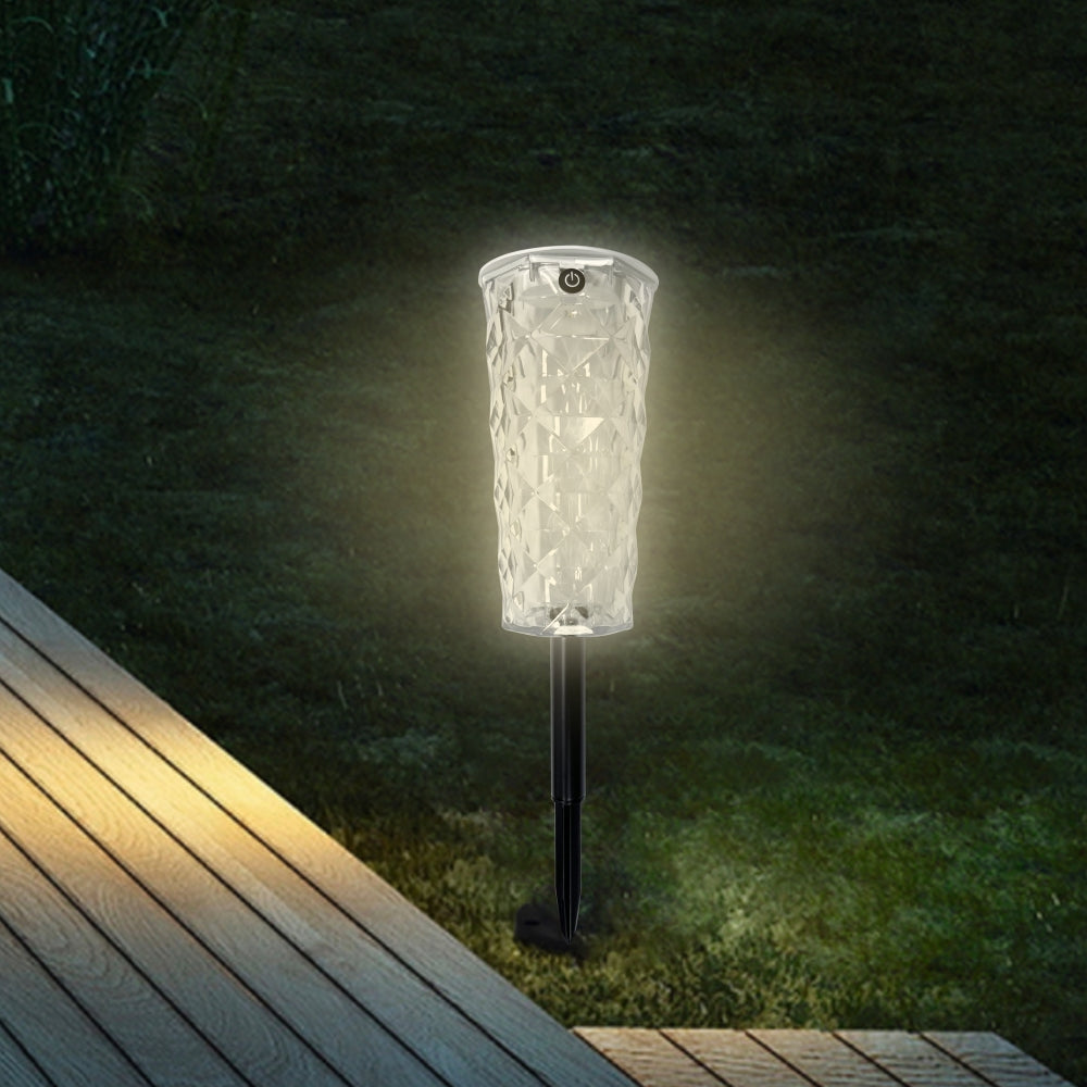 Havenlia solar rose garden stake light glowing in flower bed at dusk