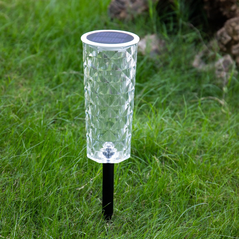 Havenlia solar rose garden stake light glowing in flower bed at dusk