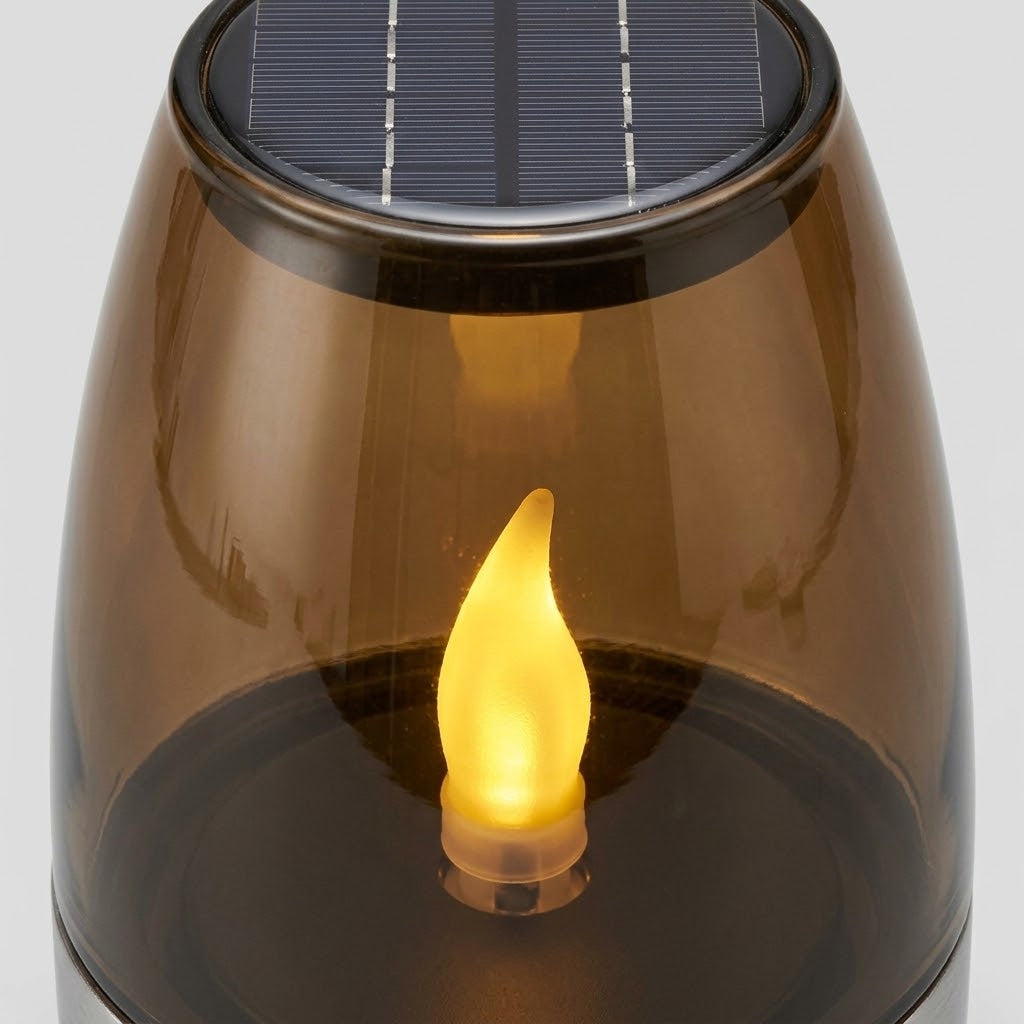 Havenlia solar warm glow garden candle lamp glowing on pathway at dusk